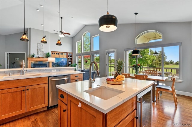 6776 Salvia Ct, Arvada, CO 80007 - kitchen featuring stainless steel dishwasher, wine cooler, a sink, wood finished floors, and high vaulted ceiling