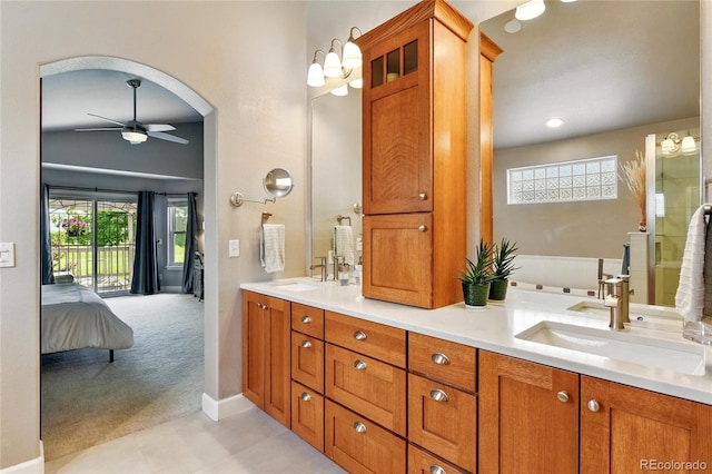 6776 Salvia Ct, Arvada, CO 80007 - ensuite bathroom featuring double vanity, a ceiling fan, baseboards, and recessed lighting