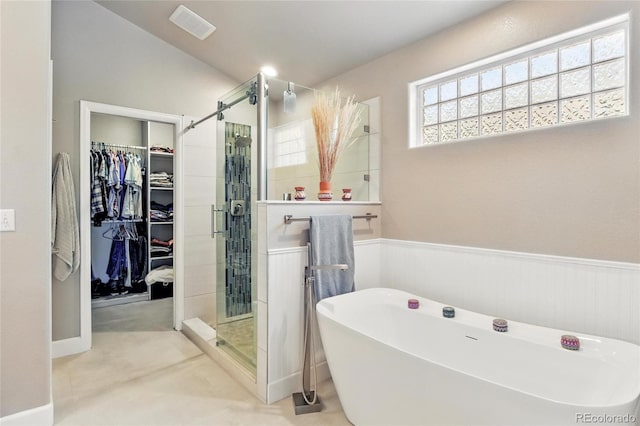 6776 Salvia Ct, Arvada, CO 80007 - bathroom featuring a freestanding bath, a shower stall, a spacious closet, and wainscoting