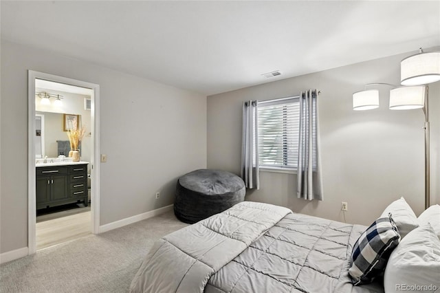 6776 Salvia Ct, Arvada, CO 80007 - bedroom featuring light colored carpet, baseboards, a sink, and ensuite bathroom
