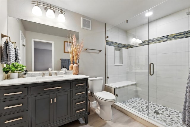 6776 Salvia Ct, Arvada, CO 80007 - full bath featuring toilet, vanity, a shower stall, and wood finished floors