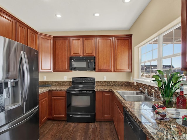 kitchen featuring black appliances, dark wood-type flooring, and sink