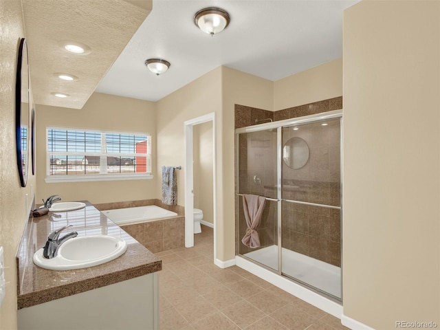 bathroom with a textured ceiling, an enclosed shower, tile patterned flooring, vanity, and toilet