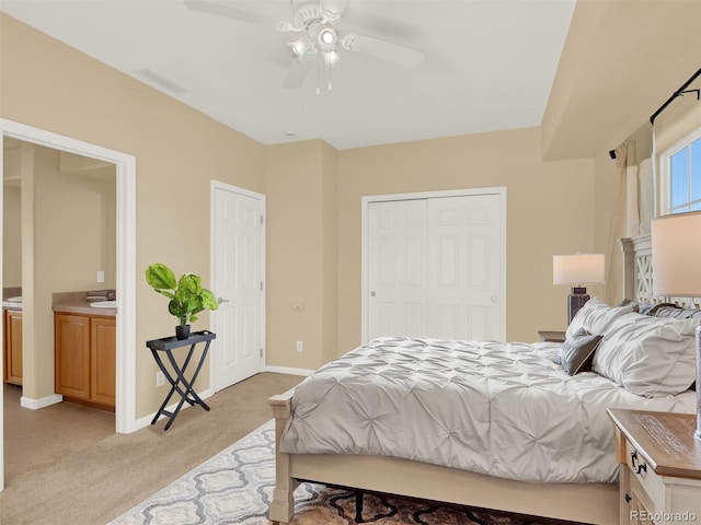 bedroom featuring ceiling fan, sink, and light carpet