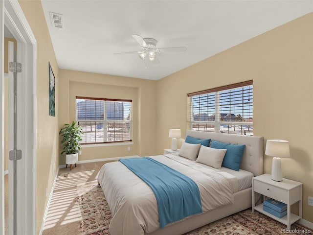 bedroom with ceiling fan and carpet flooring