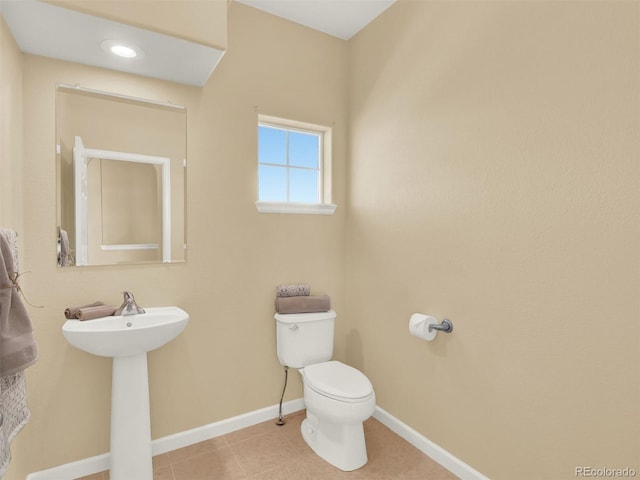 bathroom featuring sink, toilet, and tile patterned floors