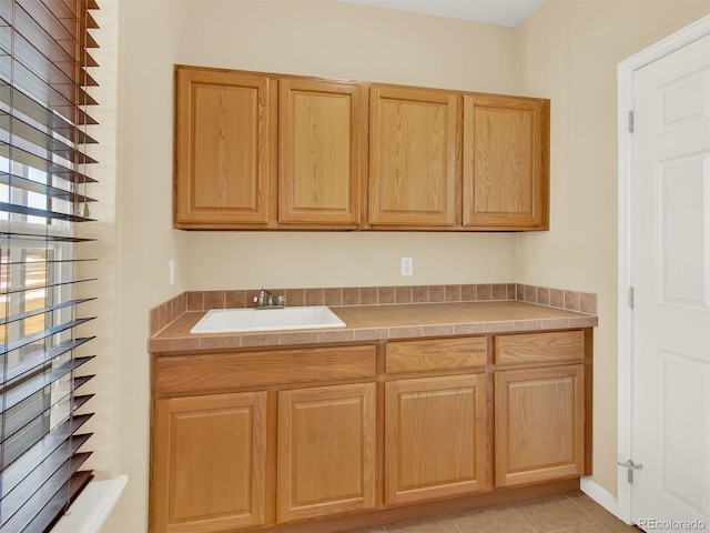 kitchen with sink and light tile patterned flooring