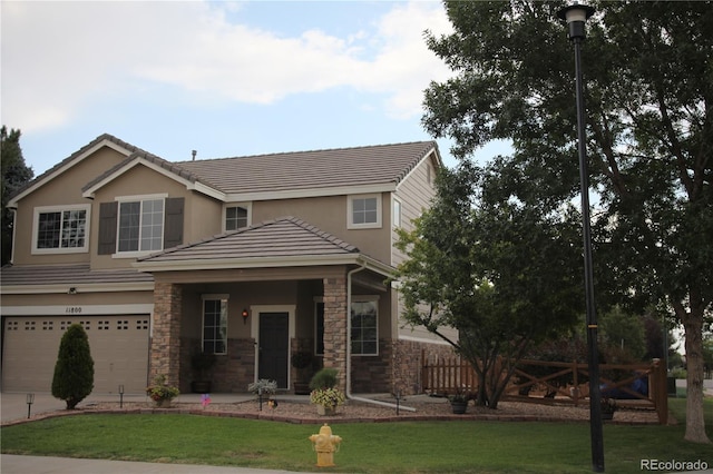 view of front facade featuring a garage and a front lawn