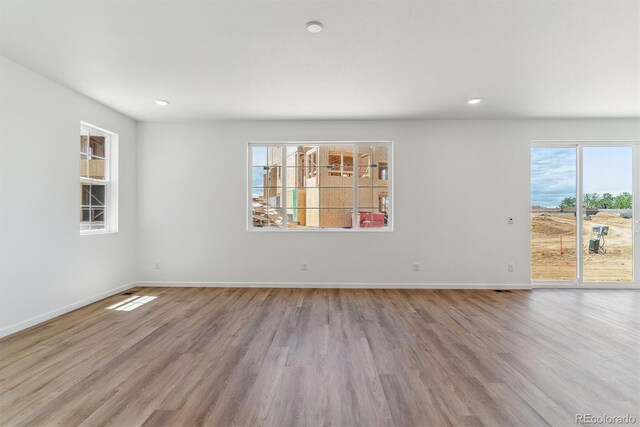 459 S Salida St, Aurora, CO 80017 - unfurnished room with wood finished floors, baseboards, and recessed lighting