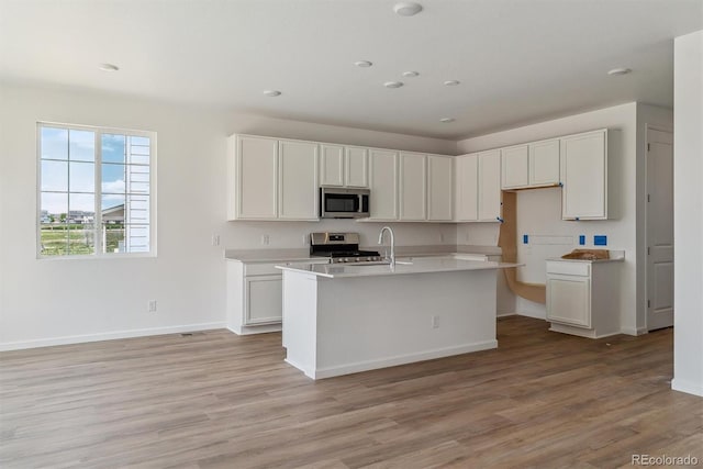 459 S Salida St, Aurora, CO 80017 - kitchen featuring appliances with stainless steel finishes, light wood-style floors, baseboards, light countertops, and recessed lighting