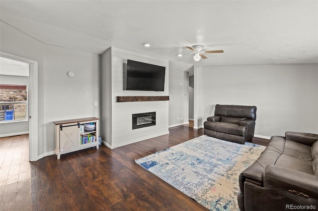 9765LAPINTURAPT La Pintura Pt, Fountain, CO 80817 - living area featuring wood finished floors, a large fireplace, ceiling fan, and baseboards