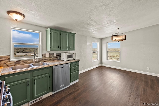 9765LAPINTURAPT La Pintura Pt, Fountain, CO 80817 - kitchen with stainless steel appliances, green cabinetry, a sink, a textured ceiling, and dark wood finished floors
