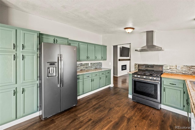 9765LAPINTURAPT La Pintura Pt, Fountain, CO 80817 - kitchen with stainless steel appliances, green cabinetry, wall chimney range hood, decorative backsplash, and a textured ceiling
