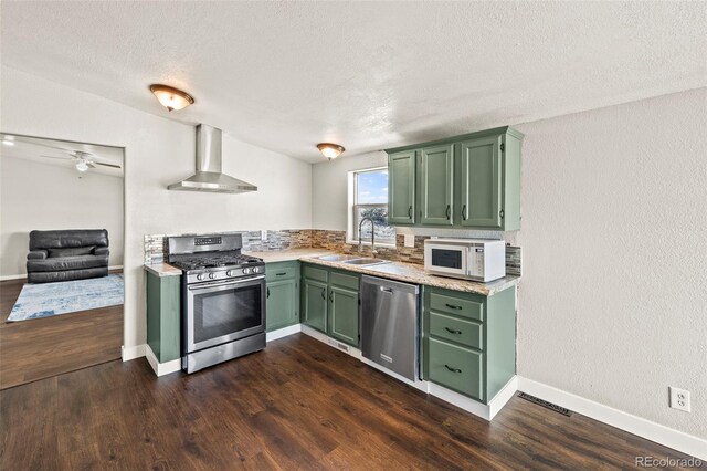 9765LAPINTURAPT La Pintura Pt, Fountain, CO 80817 - kitchen with wall chimney exhaust hood, appliances with stainless steel finishes, green cabinetry, a sink, and light countertops