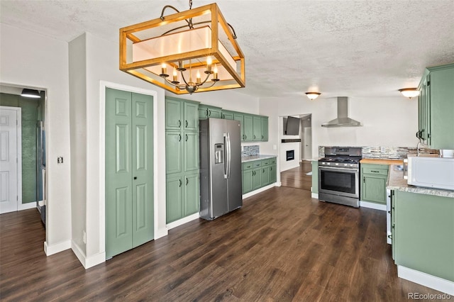 9765LAPINTURAPT La Pintura Pt, Fountain, CO 80817 - kitchen featuring appliances with stainless steel finishes, green cabinets, wall chimney range hood, a textured ceiling, and a chandelier