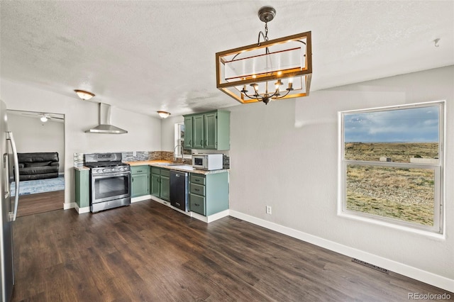 9765LAPINTURAPT La Pintura Pt, Fountain, CO 80817 - kitchen featuring green cabinetry, appliances with stainless steel finishes, wall chimney exhaust hood, a sink, and baseboards