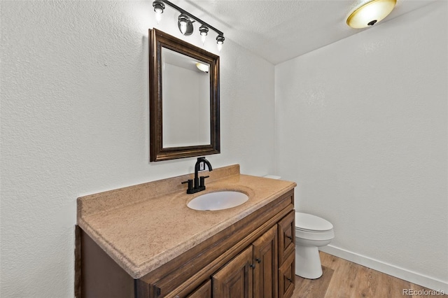 9765LAPINTURAPT La Pintura Pt, Fountain, CO 80817 - bathroom with vanity, toilet, wood finished floors, and baseboards