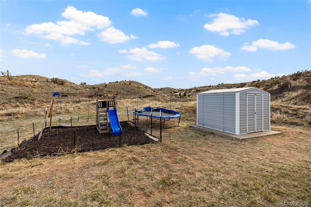 9765LAPINTURAPT La Pintura Pt, Fountain, CO 80817 - view of grassy yard featuring a trampoline, a playground, and a mountain view