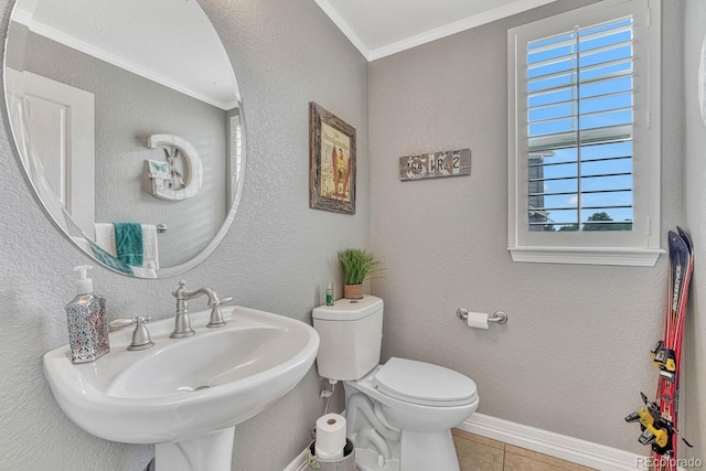 bathroom with crown molding, tile patterned floors, toilet, and sink