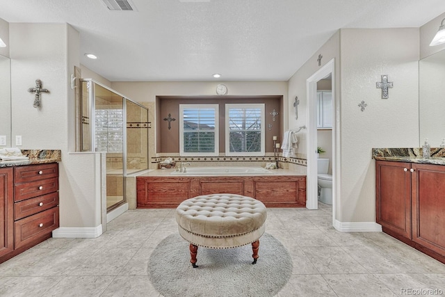 bathroom featuring walk in shower, vanity, toilet, and a textured ceiling