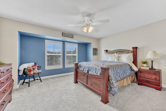 carpeted bedroom with ceiling fan and a textured ceiling