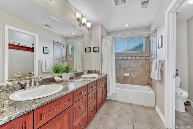 full bathroom with vanity, toilet, shower / bath combo, tile patterned floors, and a textured ceiling