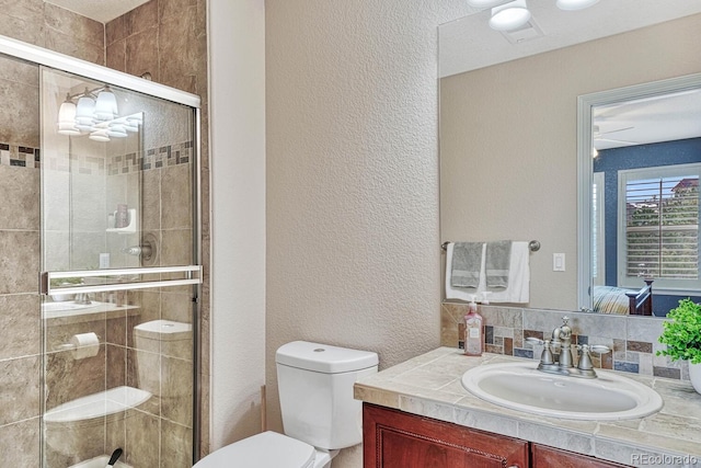 bathroom with vanity, toilet, and an enclosed shower