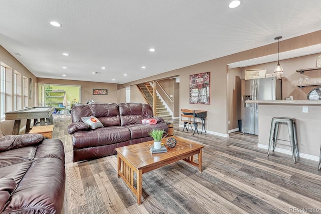 living room with hardwood / wood-style flooring, billiards, and a textured ceiling