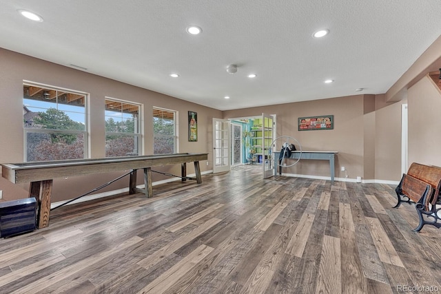 workout room featuring hardwood / wood-style flooring and a textured ceiling