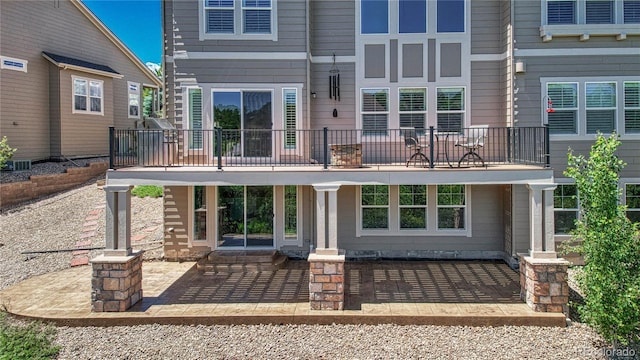 back of property with a balcony and central air condition unit