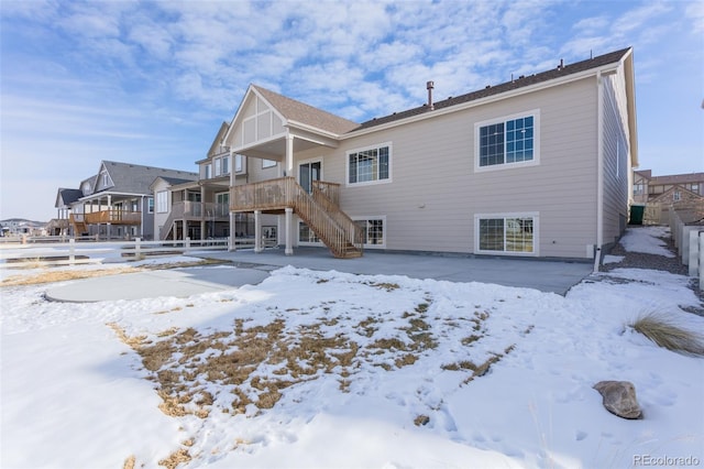 snow covered property with a wooden deck