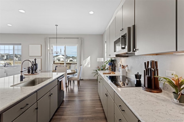 kitchen featuring gray cabinets, appliances with stainless steel finishes, sink, and decorative light fixtures