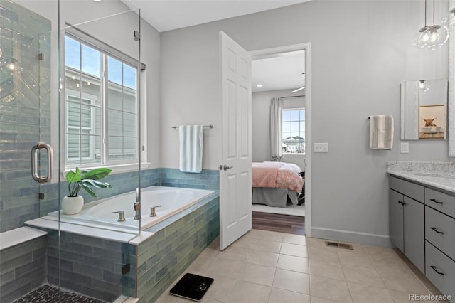 bathroom with plus walk in shower, vanity, and tile patterned flooring