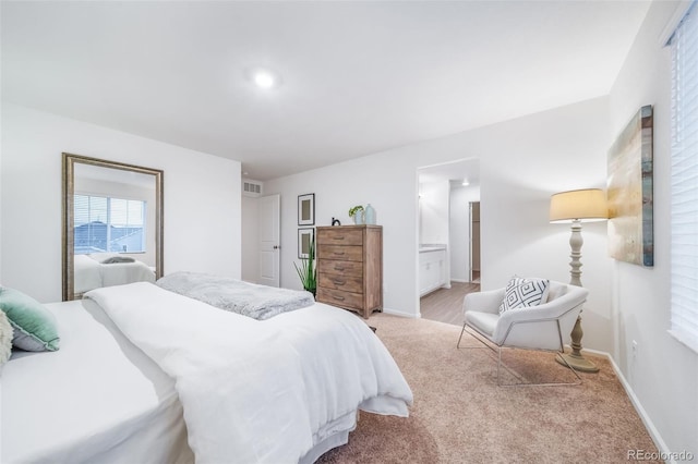 carpeted bedroom featuring ensuite bathroom