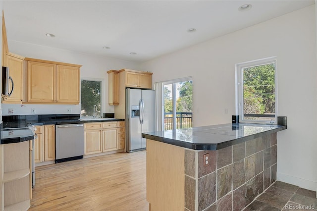 kitchen with light brown cabinetry, stainless steel appliances, recessed lighting, and a sink