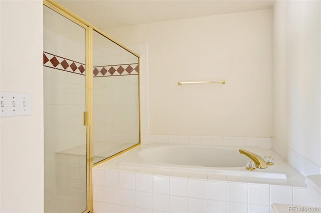full bathroom featuring a shower stall and a garden tub