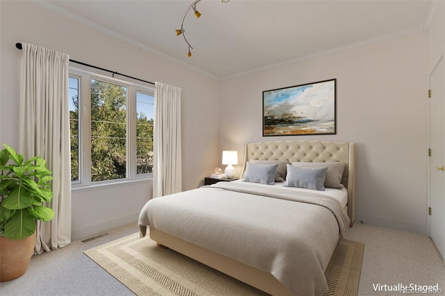 bedroom featuring crown molding, visible vents, and carpet