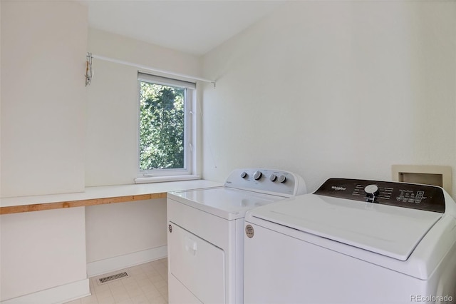 laundry area with independent washer and dryer, laundry area, and visible vents