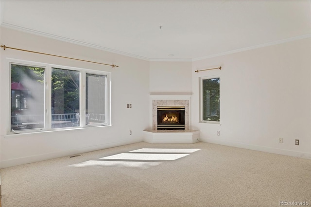 unfurnished living room featuring visible vents, crown molding, a tile fireplace, carpet floors, and baseboards