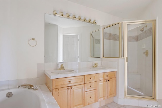bathroom with double vanity, a sink, and a stall shower