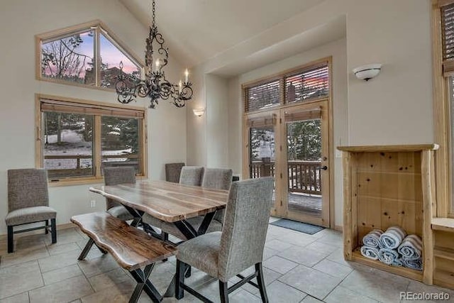 tiled dining area with a chandelier and high vaulted ceiling