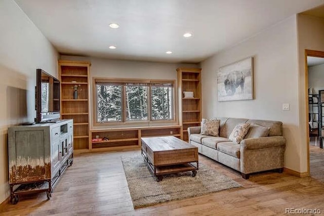 living area with wood finished floors, recessed lighting, and baseboards