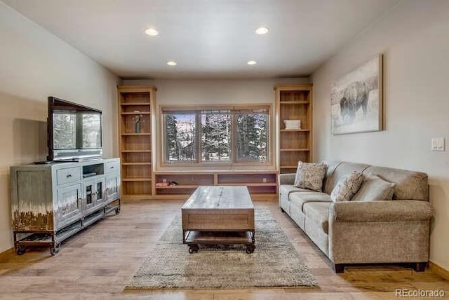 living room featuring plenty of natural light, light wood-style flooring, and recessed lighting