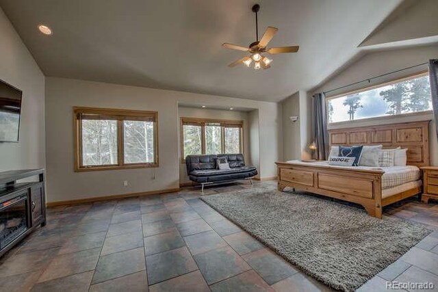 bedroom with lofted ceiling, baseboards, and a ceiling fan