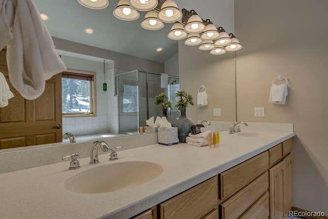 full bathroom with a shower stall and double vanity