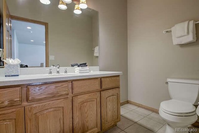 bathroom with toilet, tile patterned flooring, vanity, a chandelier, and baseboards