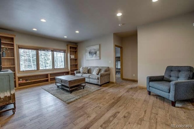 living area featuring recessed lighting, wood finished floors, and baseboards