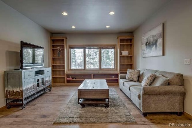 living room featuring recessed lighting and light wood-style flooring