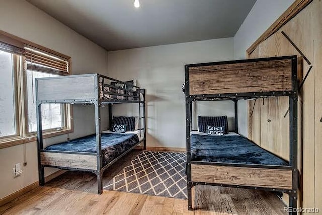 bedroom featuring wood finished floors and baseboards