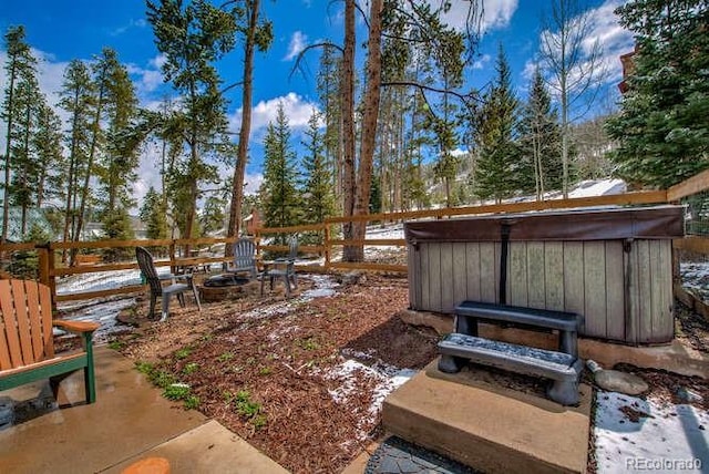 view of yard featuring a hot tub and a fire pit